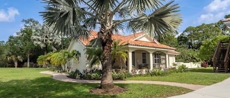 DRIVEWAY SIDE OF HOUSE SHOWING MASTER BEDROOM LANAI & WALKWAY TO FRONT DOOR