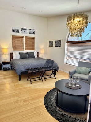 Studio suite with one king bed and two indoor sitting chairs