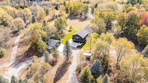 The home is nestled on 11 private acres with 1100 feet of Betsie River frontage.