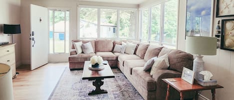 Relax and unwind: TV and sectional couch in cozy living room.