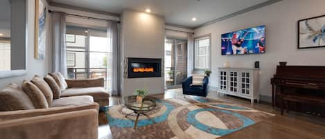 1st Floor: Stunningly designed living room featuring an electric fireplace, piano, flat-screen SMART TV and designer furnishings!