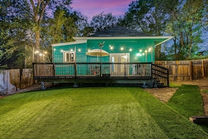 Artificial turf in fully fenced backyard with...