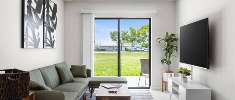 Living room with modern couch, with 65 inch smart tv, wifi and live tv