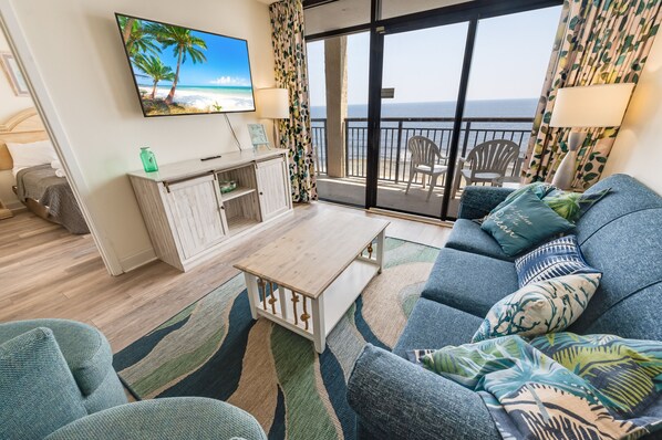 - Relax in this cozy living space with a stunning oceanfront view - Enjoy the beachy décor, plush seating, and a mounted smart TV for entertainment - Step onto the balcony to feel the sea breeze and soak in the coastal vibes