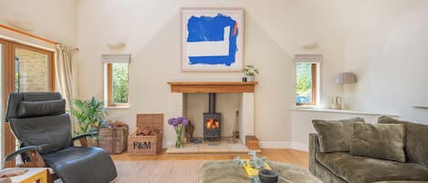 Beautiful double height sitting room with log burner.