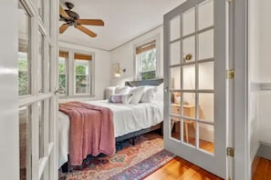 French doors with bamboo privacy shades lead into the bedroom.