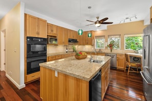 Kitchen with granite countertops and center island.