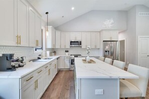 Oversized chef's kitchen with island and seating area