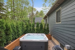 Hot tub area with privacy trees