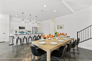This modern, well-stocked kitchen features sleek finishes, ample counter space, and a spacious dining table—perfect for gathering and easily preparing any meal during your vacation.