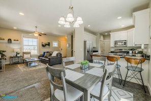 Step into a culinary oasis as you feast your eyes on this stylish kitchen and inviting dining area, a perfect setting to indulge in culinary delights with loved ones.