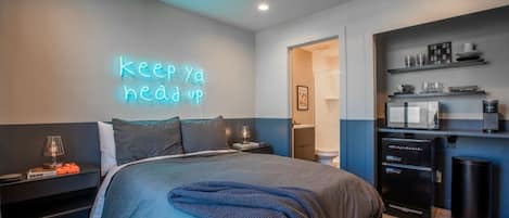 Experience sleek comfort in this modern condo. Comfy double bed, mini fridge, and microwave provide convenience. The bathroom door ensures privacy. Enjoy a stylish and inviting retreat with all the essentials for a comfortable stay.