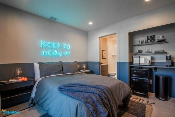 Experience sleek comfort in this modern condo. Comfy double bed, mini fridge, and microwave provide convenience. The bathroom door ensures privacy. Enjoy a stylish and inviting retreat with all the essentials for a comfortable stay.