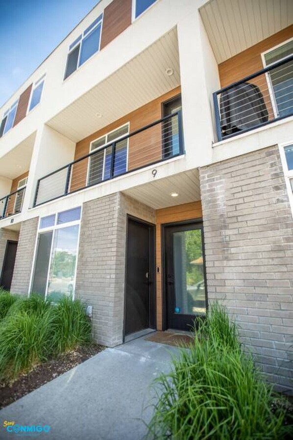 Inviting condo entrance with balcony. Experience comfort and scenic views in this serene living space. Sit back, relax, and enjoy the harmonious blend of comfort, style, and natural beauty in this exquisite living area.