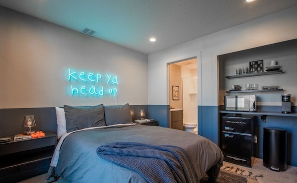 Experience sleek comfort in this modern condo. Comfy double bed, mini fridge, and microwave provide convenience. The bathroom door ensures privacy. Enjoy a stylish and inviting retreat with all the essentials for a comfortable stay.