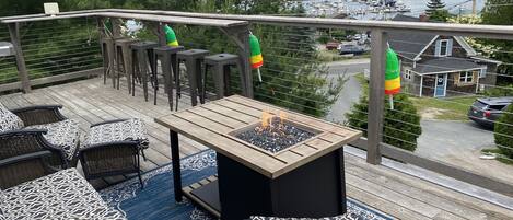 Deck furniture, railing bar top, and outdoor fire pit for enjoying the views