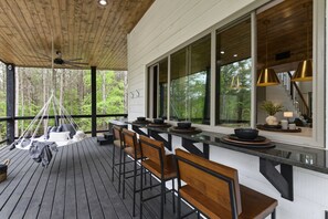 Back patio area with a sitting bar area & swing