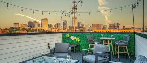 4th Floor: Gorgeous Rooftop offering stunning city views, firepit, and multiple lounge areas with outdoor dining under bistro lights.