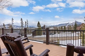 Enjoy the fresh mountain air and stunning views from the spacious deck. This area provides a great outdoor living space with a BBQ, a picnic table, and patio furniture with seating for up to 15.