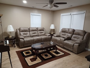 Living room has 2 sofa recliners 65" tv mounted.