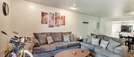 Living Room features 2 sofas, 55" Smart TV w/ YouTube TV Live & bicycles to enjoy