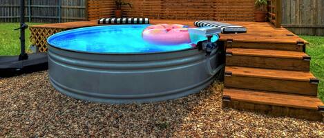 Enjoy an afternoon outdoor soak in our 9 ft cowboy pool with umbrella.