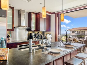 Gather around the island with family and friends enjoy views from the lanai