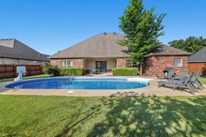 Out back, relax in our large private pool with basketball goal and chaise loungers!