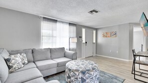 Rest your feet on the soft ottoman as you enjoy the warmth of the wooden floors underfoot.