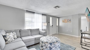 Rest your feet on the soft ottoman as you enjoy the warmth of the wooden floors underfoot.