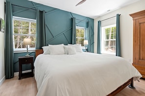 Primary bedroom includes King bed, Smart TV, ceiling fan, room darkening blinds, hangers and extra blankets