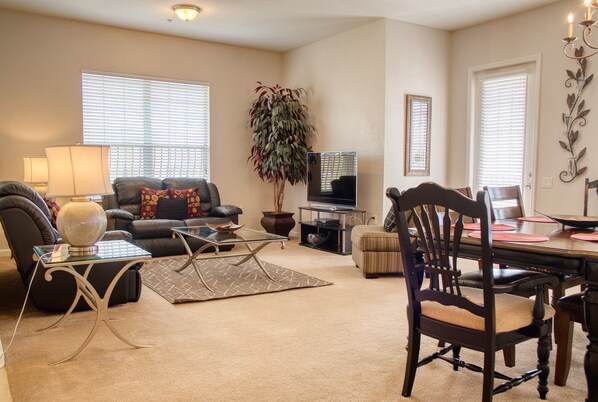 Living room with TV. You can watch live tv or use to stream your favorite content using your personal account. Dining area