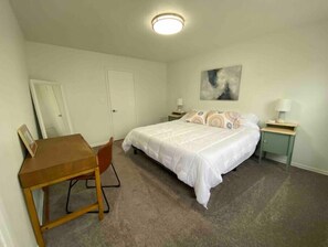 King sized bed in massive bedroom, with bedside tables and USB chargers.