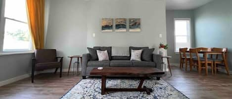 Living room, reading nook, and dining area with plenty of natural light.