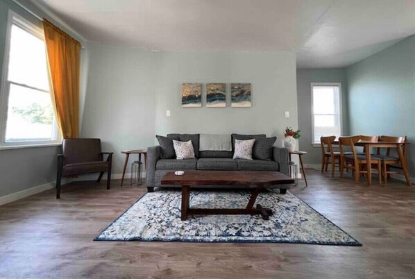 Living room, reading nook, and dining area with plenty of natural light.