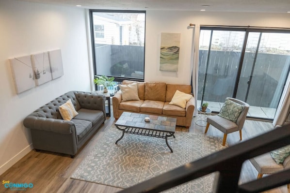 Discover the perfect blend of style and comfort in our inviting living area. Relax on the plush sofa, enjoy the warmth of the cozy fireplace, and bask in the natural light streaming through the windows.