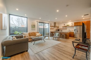 Experience seamless living in our combined living room and kitchen. This open-concept space fosters a sense of togetherness, allowing you to relax on the comfortable couch while staying connected to the heart of the home.