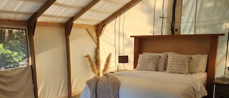 The definition of "Glamping" with the world's coziest bed.