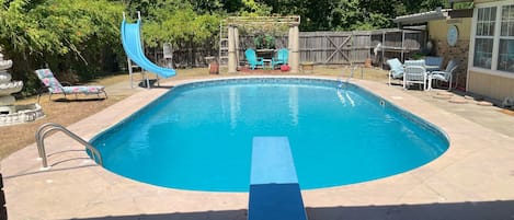 Large 10’ deep pool with diving board and slide for hours of family fun