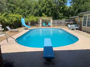 Large 10’ deep pool with diving board and slide for hours of family fun