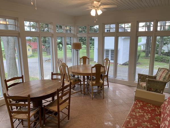 Seating in the sun room with a view of the smokehouse.