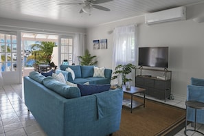 Open plans lounge concept with smart TV, ceiling fan and A/C.