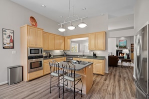Fully stocked kitchen with island seating.