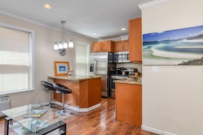 The newly remodeled space features a full kitchen with stainless appliances and granite countertops.