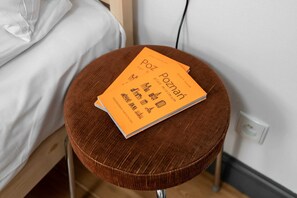A bedside table holding a charming welcome card, adding a personal touch for guests.
