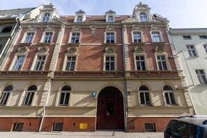 A beautifully restored historic building exterior, showcasing ornate architectural details and a welcoming entrance.
