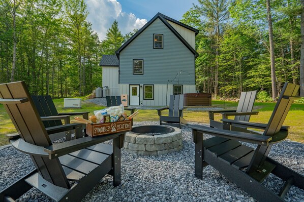 Expansive backyard: firepit, cornhole, hot tub, music, perfect for outdoor fun and relaxation.
