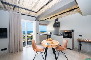 Kitchen / Dining Room leading to the terrace with seafront and country views