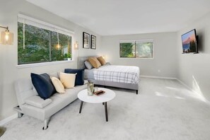 Our king-size bed with loveseat setting makes you feel like staying in a high-end hotel! This is the big bedroom on the 2nd floor.