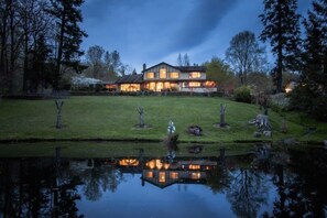 The image of our humble house is mirrored in the pond in our private yard. 寒舍倒映在我们私人庭院的池塘里。